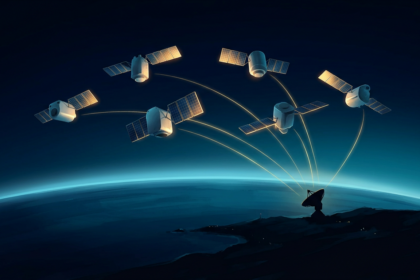 Six commercial surveillance satellites in formation above a night side Earth, downlinking to a single ground station dish